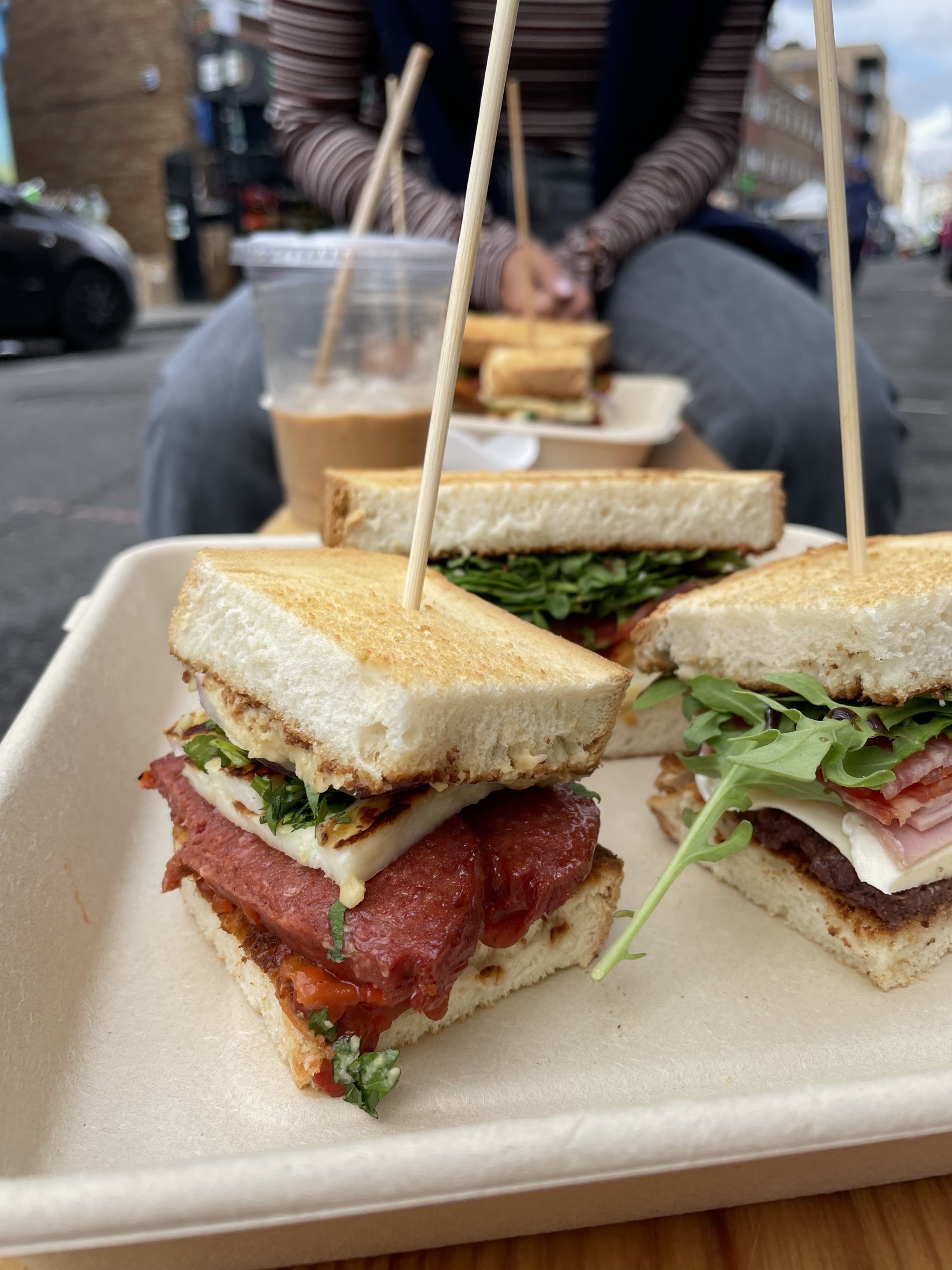 Freshly toasted sandwiches at Humble Hands Deli, stacked and served on a tray